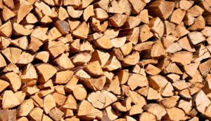 A close-up of a large stack of chopped firewood pieces arranged tightly together, resembling the neatly organized archives of a Knowledge Center.